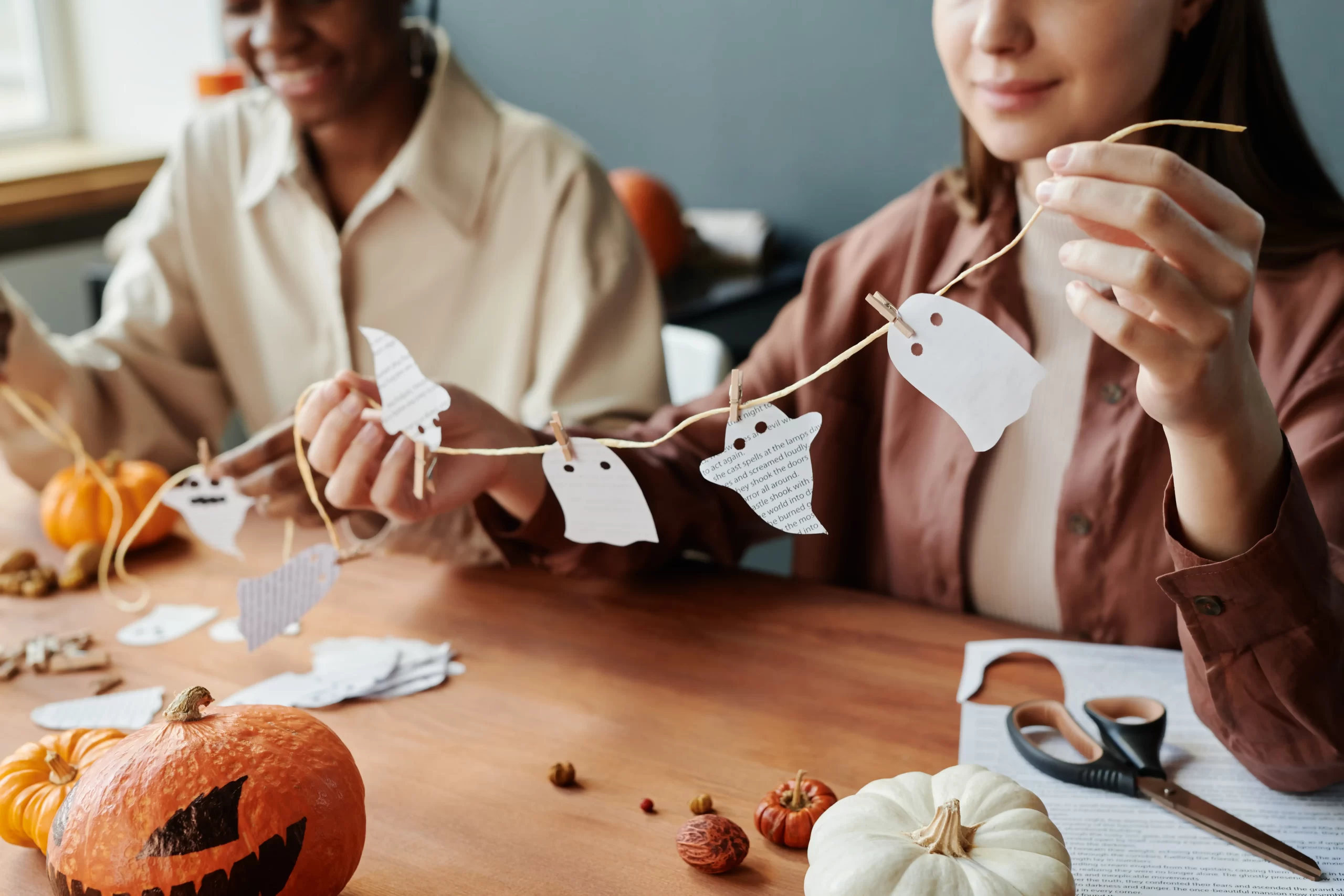 halloween decoration hands of young woman in casualwear holding thread