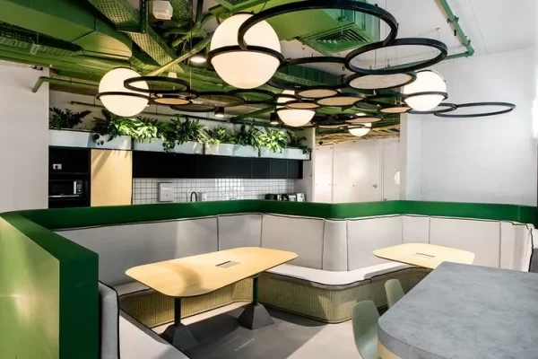 Green color office space with desks