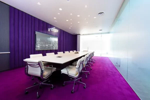 Purple color themed conference room with white desk